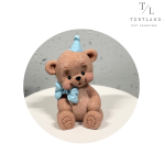 Шоколадна фігурка "Ведмедик коричневий з блакитним бантиком та ковпачком"